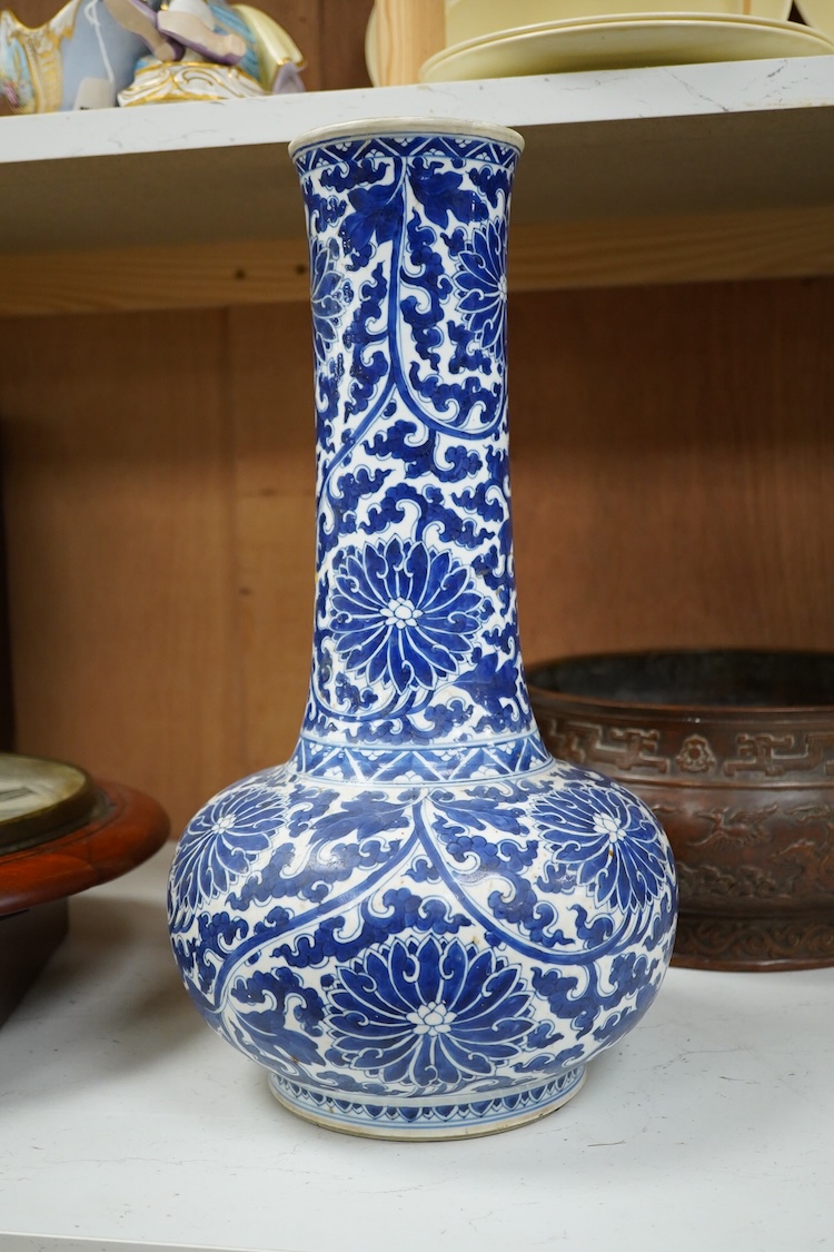A Chinese blue and white bottle vase with lotus decoration, restored, Kangxi Period, 44cm high